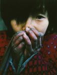 Lu-Guang-A-young-girl-warms-her-hands-in-winter.-Her-father-is-infected-with-HIV-and-still-cares-for-five-children-and-his-elderly-parents